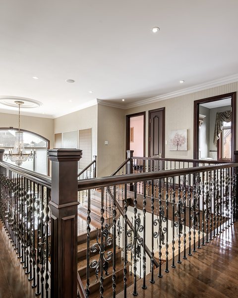 Upstairs landing with a wrought-iron railing